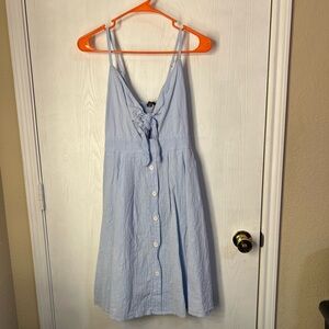 Light Blue button up dress with a tie in the front and adjustable straps